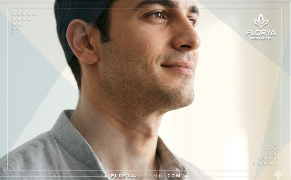 Confident male showing perfect neck and jawline contour after successful voice surgery